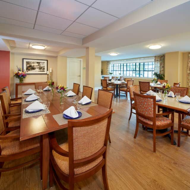 Interior view of Forestdale Park senior living community featuring dining room with art and decor.