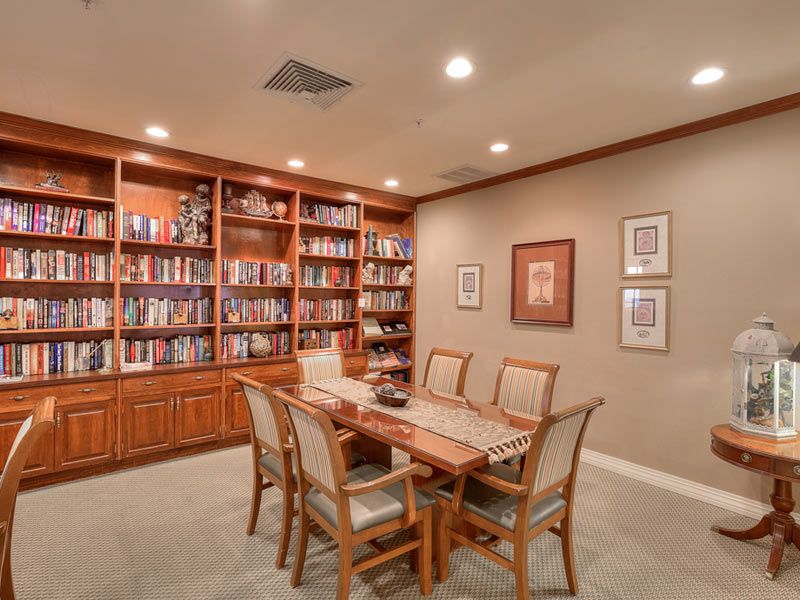 Interior view of Azalea Estates in New Iberia featuring a dining room, library, and tasteful home decor.