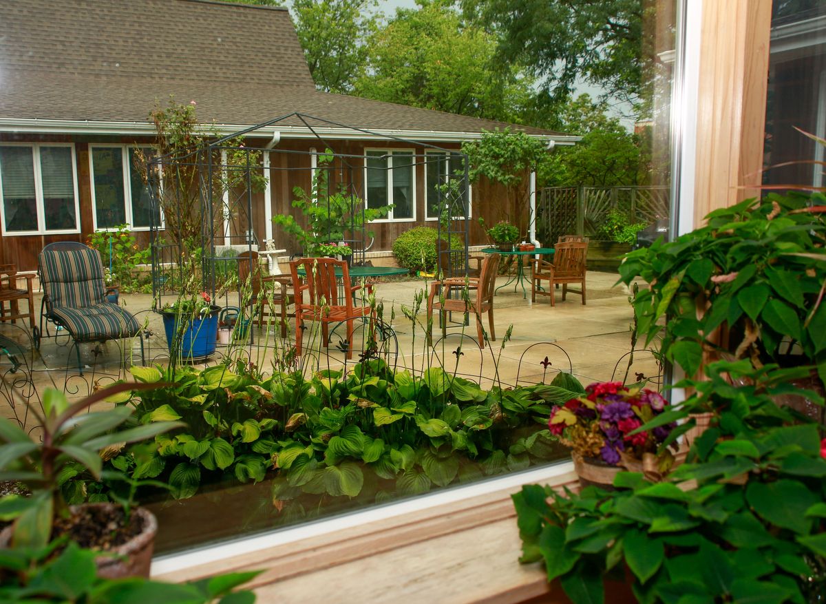 Senior living community, Winter Growth - Marge's Memory Care, featuring a garden patio with potted herbs.