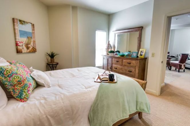 Interior design of a bedroom at The Meridian At Waterways senior living community.