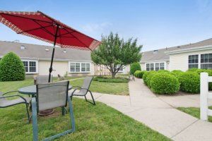 Seaton Chesterfield senior living community featuring lush lawns, patio furniture, and modern architecture.