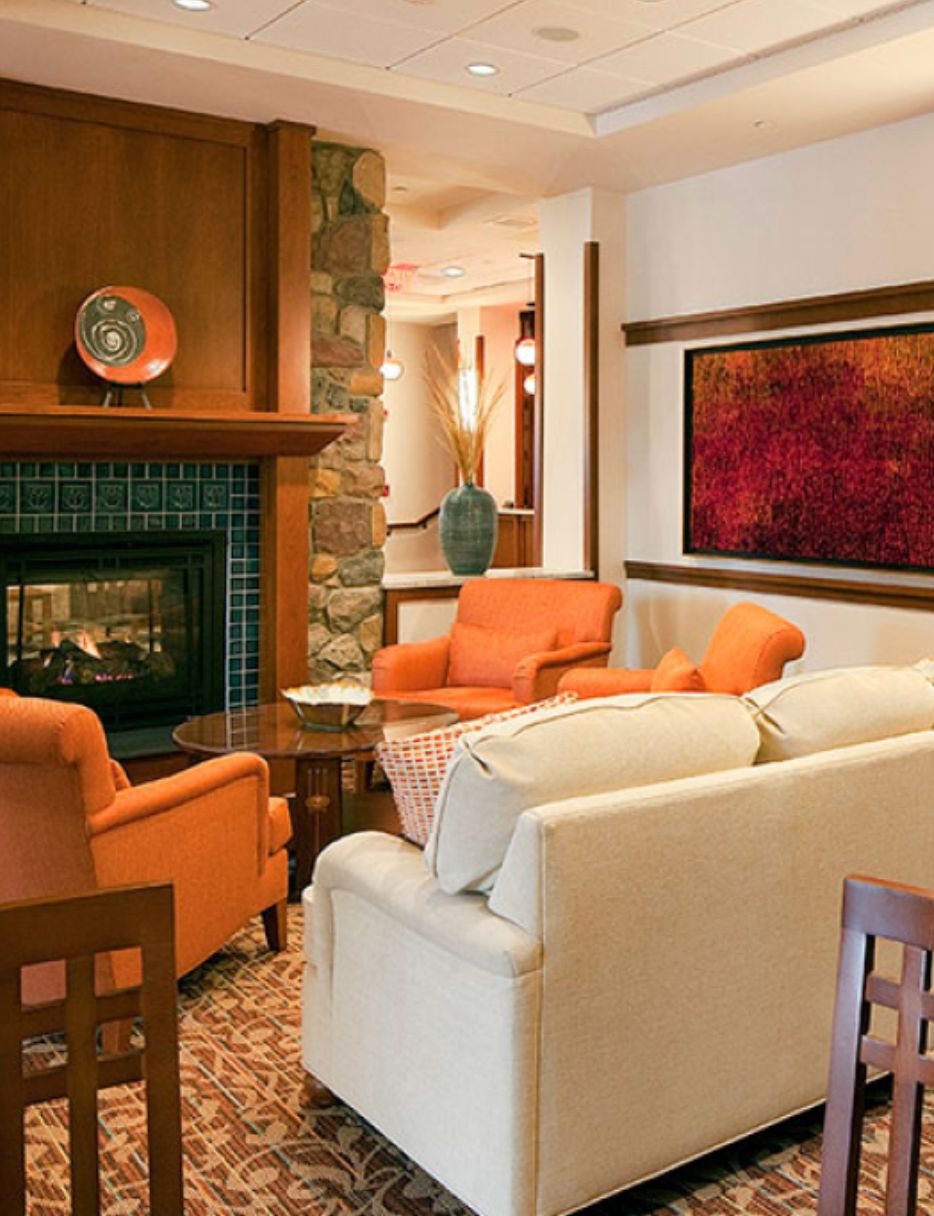 Interior view of Waterstone at Wellesley senior living community featuring a cozy fireplace and elegant decor.