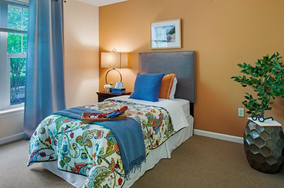 Interior view of a bedroom at Sunrise of Chesterfield senior living community.