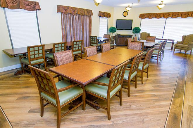 Interior view of Summit Assisted Living in Tarzana featuring dining room with wooden furniture.