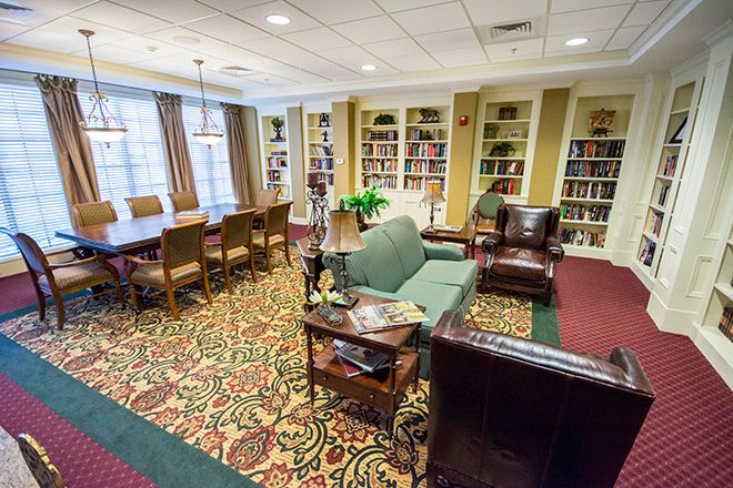 Senior living community Brookdale Green Hills Cumberland featuring cozy library and tennis facilities.