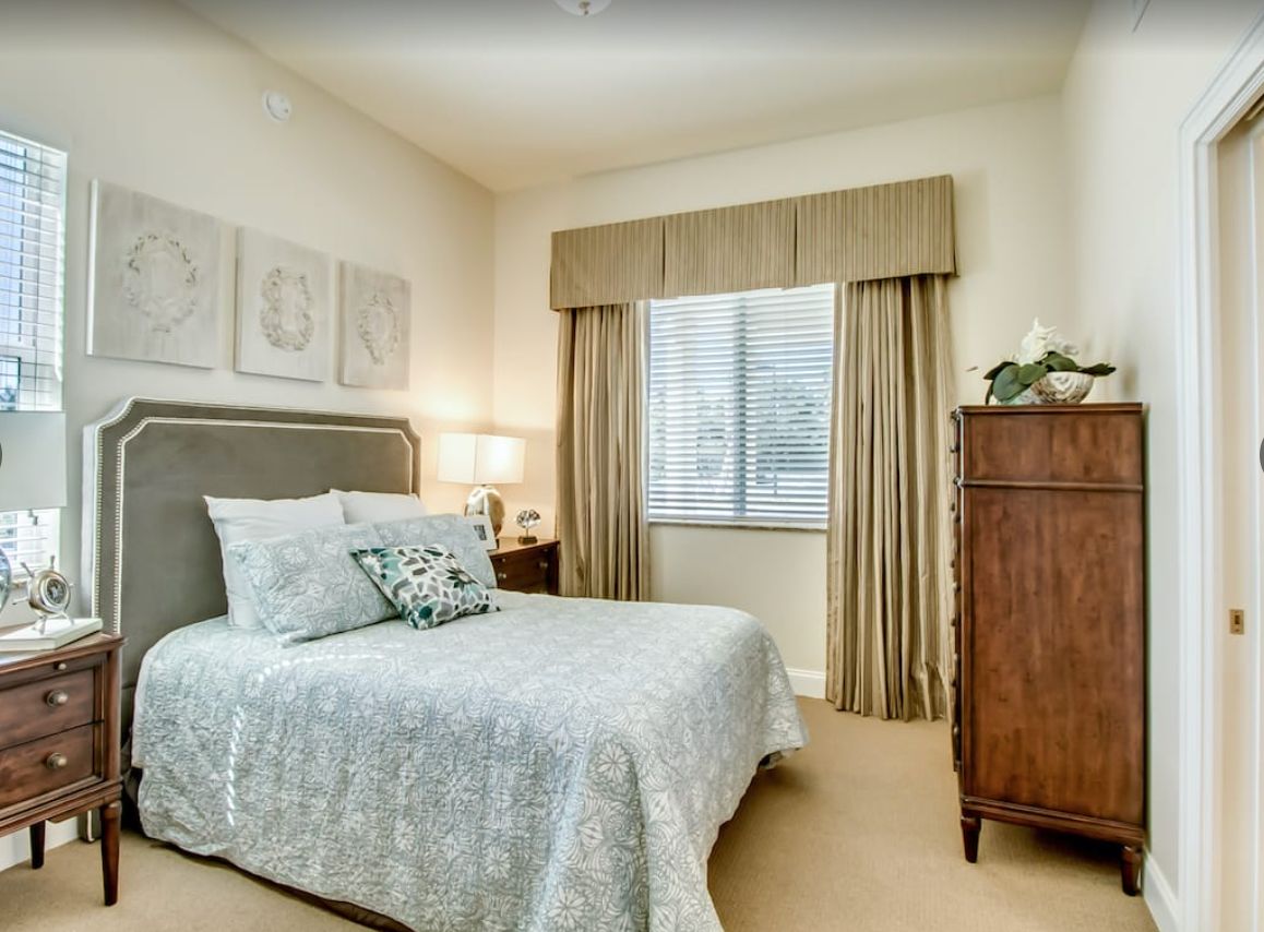 Interior design of a cozy bedroom with elegant furniture at Discovery Village At Sarasota Bay.
