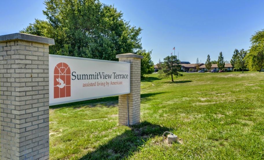 Advertisement for Summit View Terrace senior living community featuring lush park, vehicles, and mailbox.