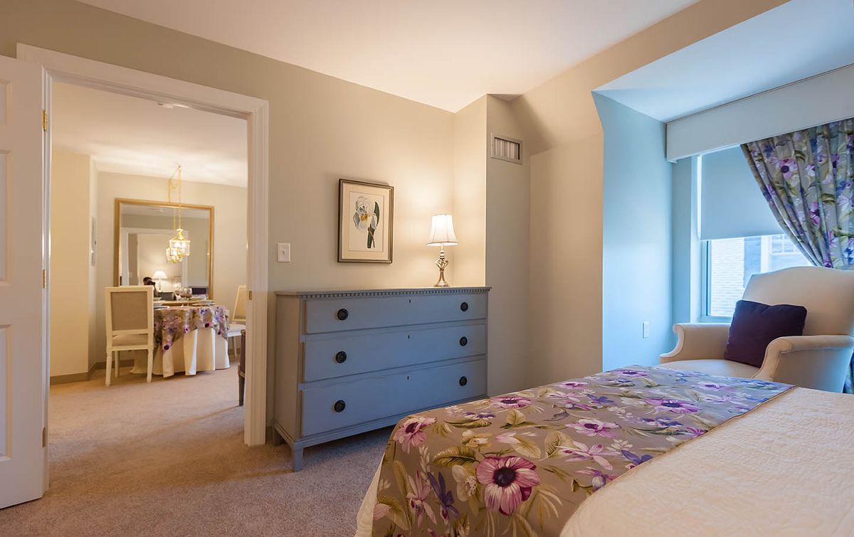 Interior design of a cozy bedroom with furniture at Providence House Senior Living Community.