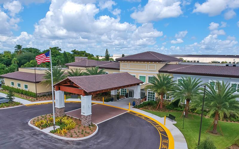 Aerial view of The Monarch, a senior living community in Coconut Creek, featuring resort-like architecture.