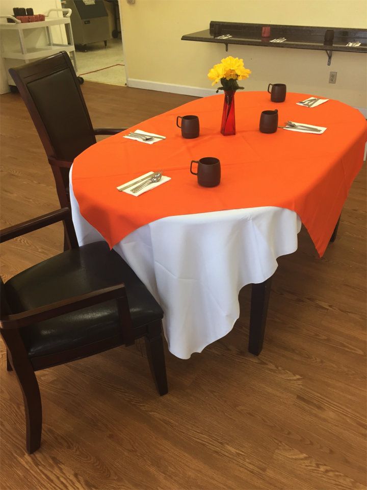 Senior living community Coral Oaks Care Living, featuring wooden furniture, coffee on dining table.