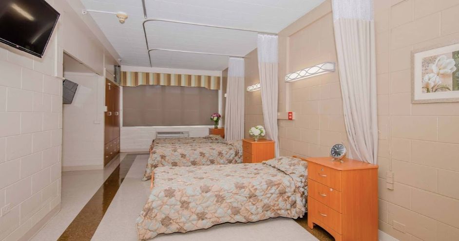 Interior view of a well-furnished bedroom at Aperion Care Burbank senior living community.