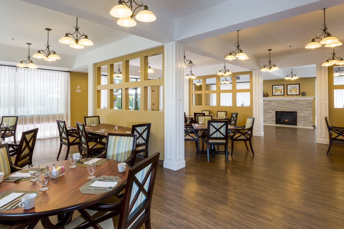 Interior view of The Groves at Tustin Assisted Living featuring dining room with hardwood floors and decor.