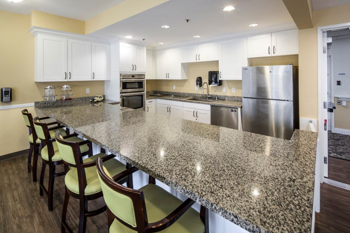 Interior view of The Groves at Tustin Assisted Living featuring a modern kitchen with appliances.