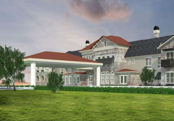 Senior living community, The Blake at Colonial Club, featuring lush lawns, waterfront views, and manor-style architecture.