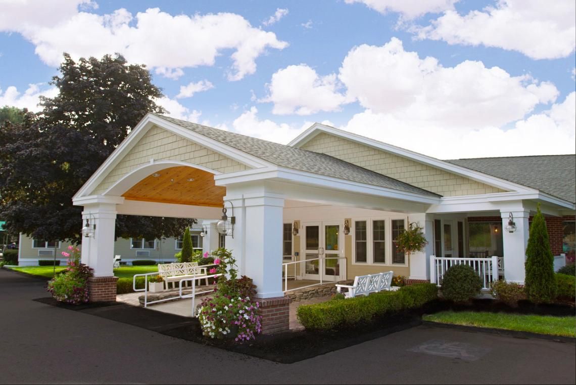 Architectural view of the Edgewood Centre senior living community with lush greenery.