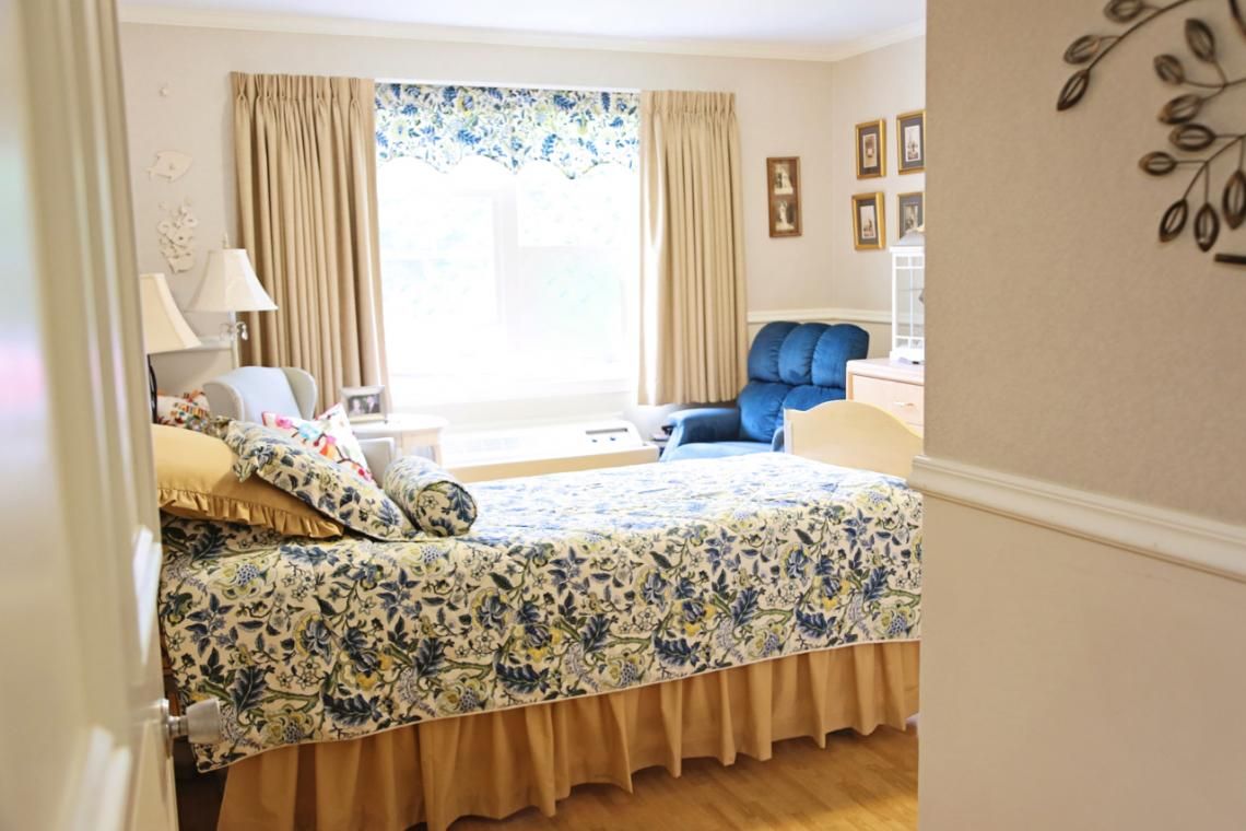 Interior view of a bedroom at The Edgewood Centre senior living community, featuring elegant home decor.