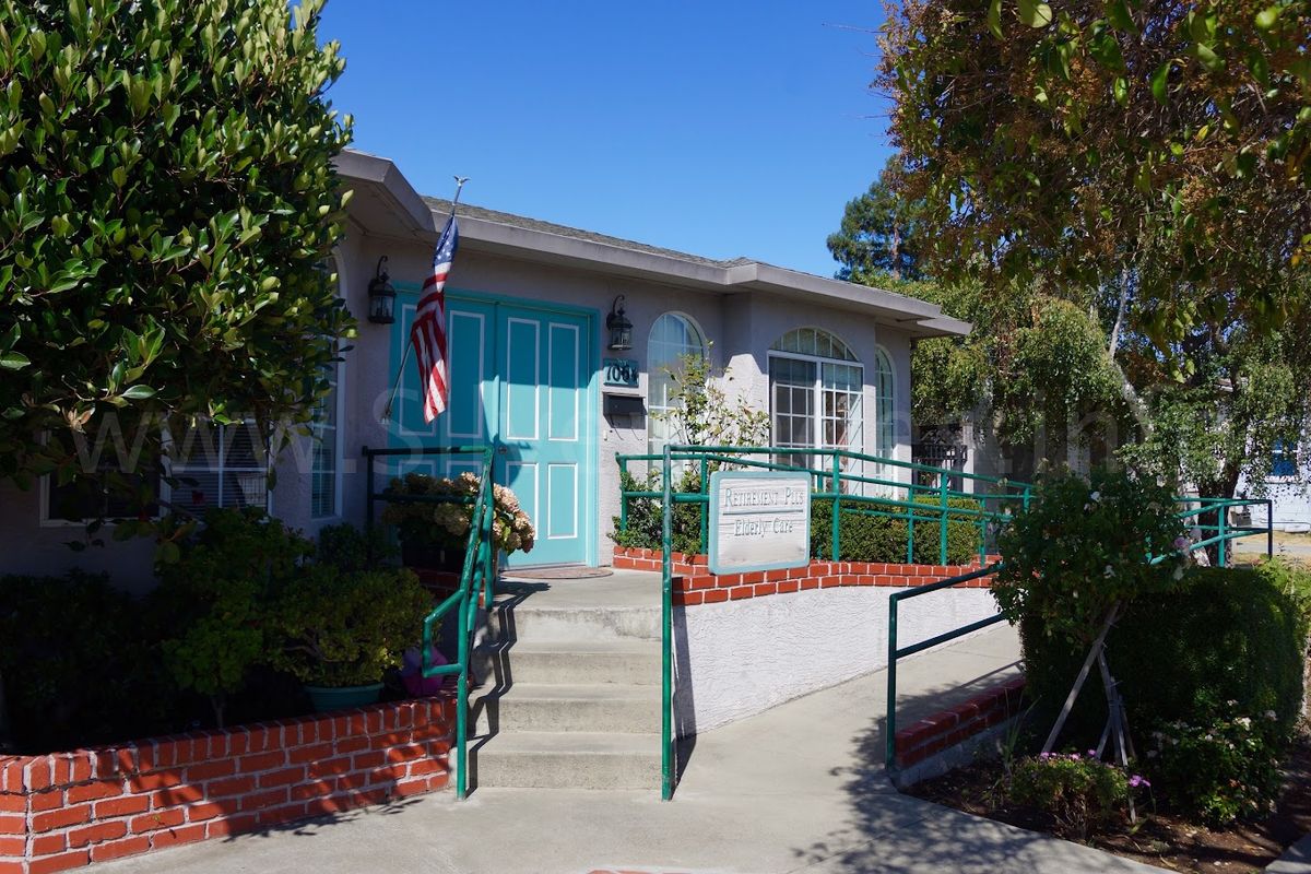 City suburban villa at Peninsula Elderly Care Home-Laurel with lush greenery and flag.