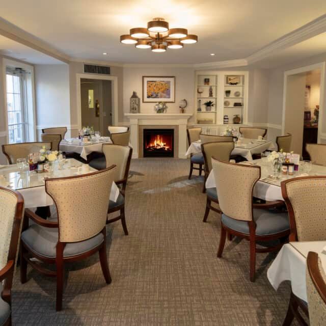 Senior living community Compass On The Bay featuring elegant dining room with art and decor.