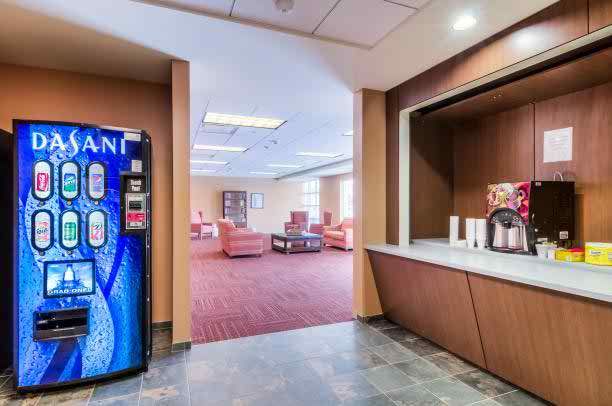 Interior view of Senior Suites of Bellwood featuring foyer, furniture, and vending machine.