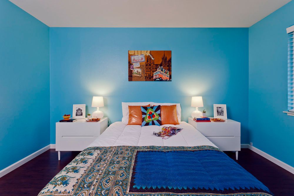 Interior view of a bedroom at Priya Living Santa Clara, featuring modern furniture and decor.