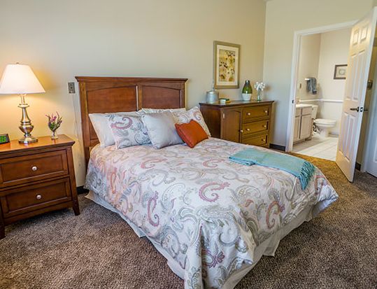 Interior view of a furnished bedroom at Brookdale Medi Park West senior living community.