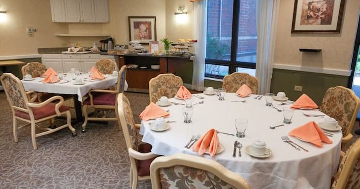 Senior living community dining room at Addolorata Villa with elegant furniture and decor.
