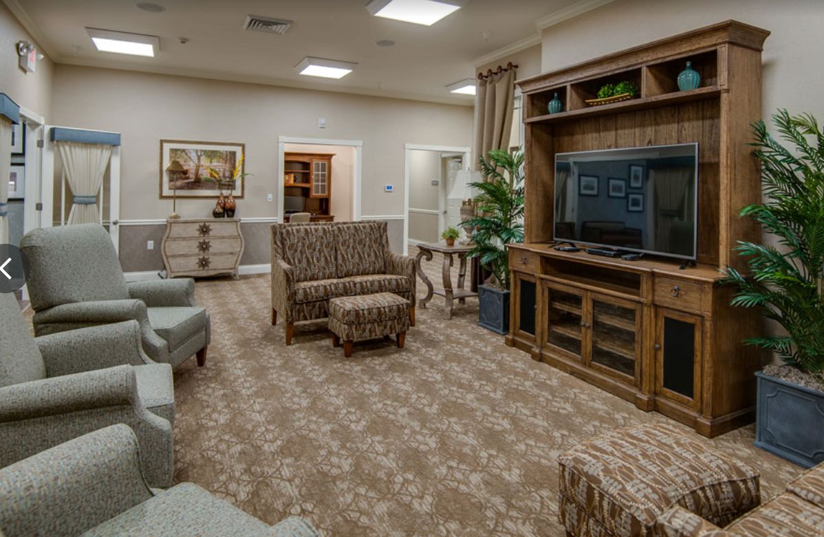 Senior living room interior at The Arbors At Centennial Pointe with modern decor, electronics, and furniture.