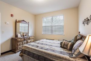 Interior view of a well-decorated bedroom at Charter Senior Living of Hermitage with modern furniture.
