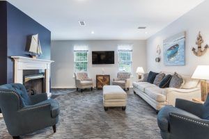 Interior view of Charter Senior Living of Hermitage featuring modern decor, furniture, and fireplace.