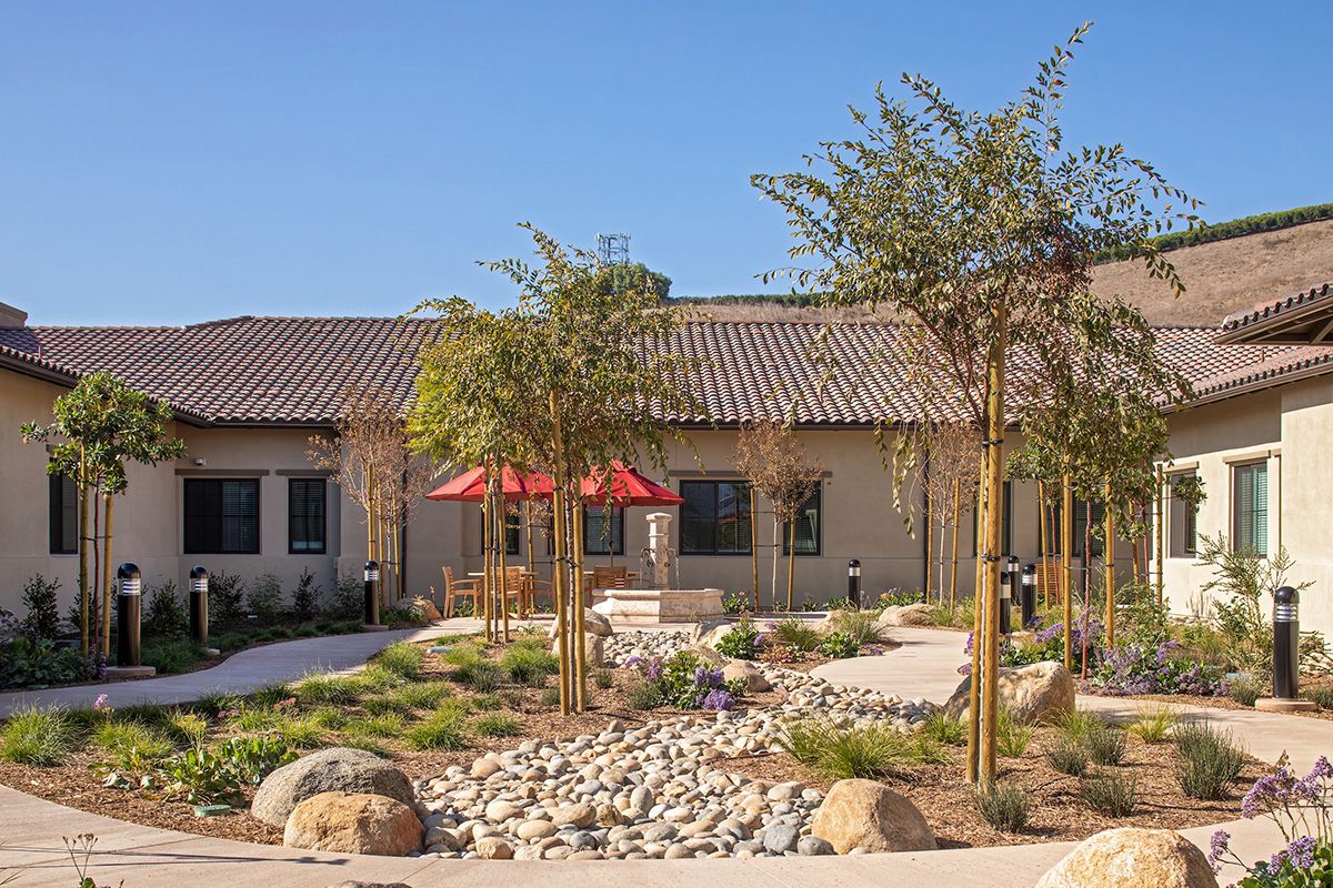 Orchards Assisted Living community featuring villa-style housing, walkways, and outdoor patios.