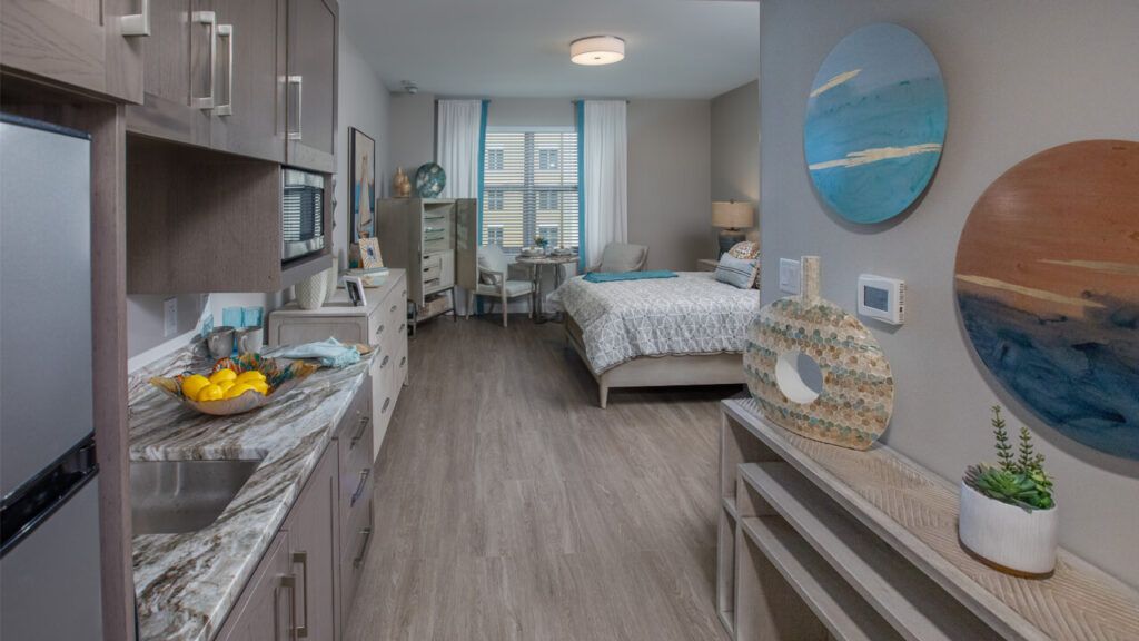 Interior view of Belmont Village Senior Living in Fort Lauderdale featuring bedroom decor and amenities.