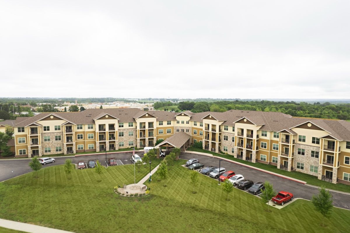 Aerial view of The Parkway Senior Living community, showcasing suburban architecture and transportation.