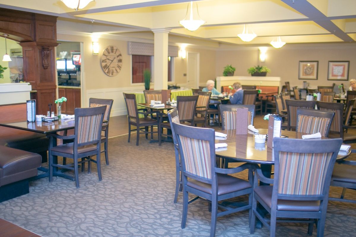 Seniors enjoying a meal in the spacious, well-designed dining room at The Parkway Senior Living.