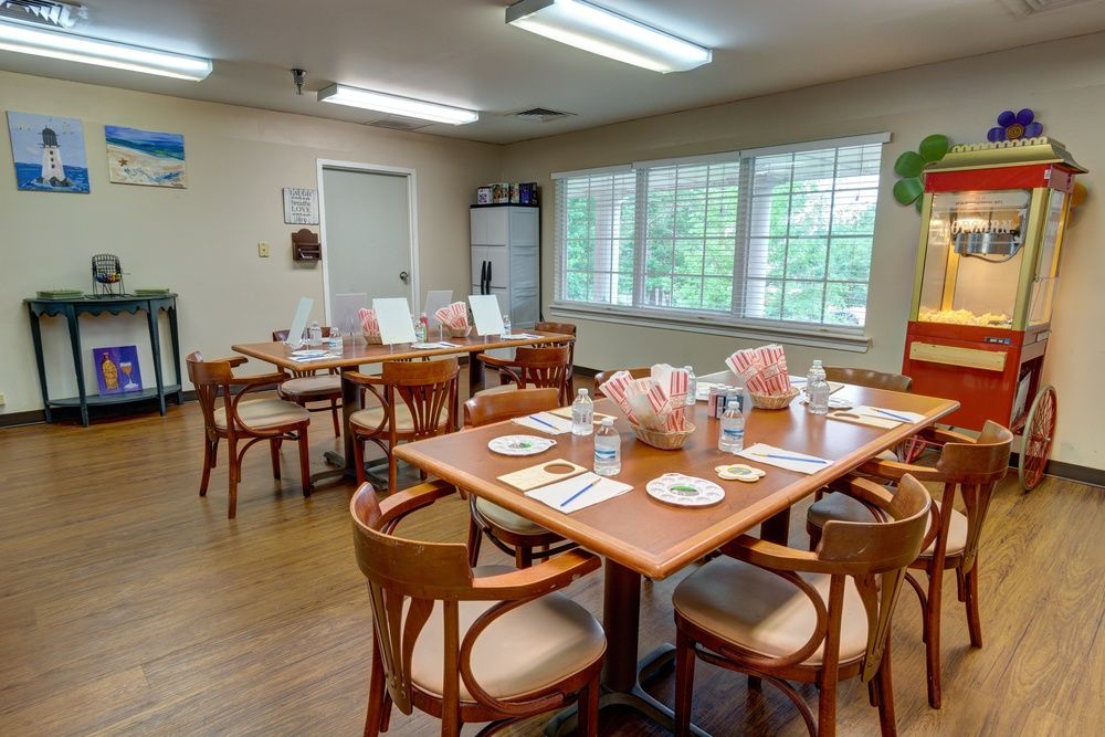 Interior view of Ridgeland Place senior living community featuring a wooden dining room setup.