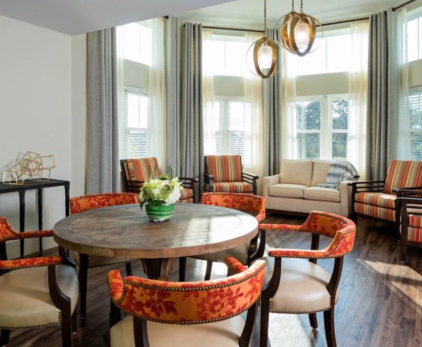 Senior living community, Maplewood at Mill Hill, featuring elegant dining room decor and architecture.