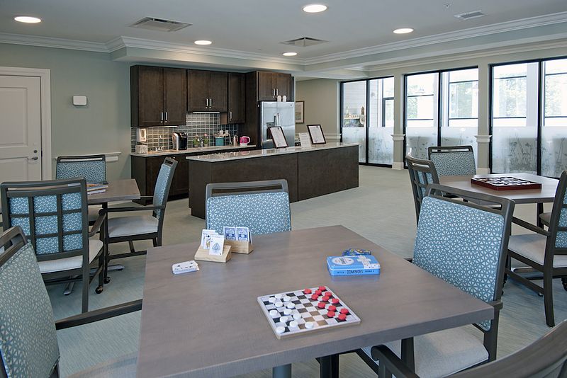 Interior view of Allegro Harrington Park senior living community with dining and living areas.