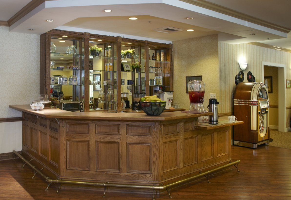 Interior view of Ivy Park at Woodland Hills senior living community featuring pub-style furniture.
