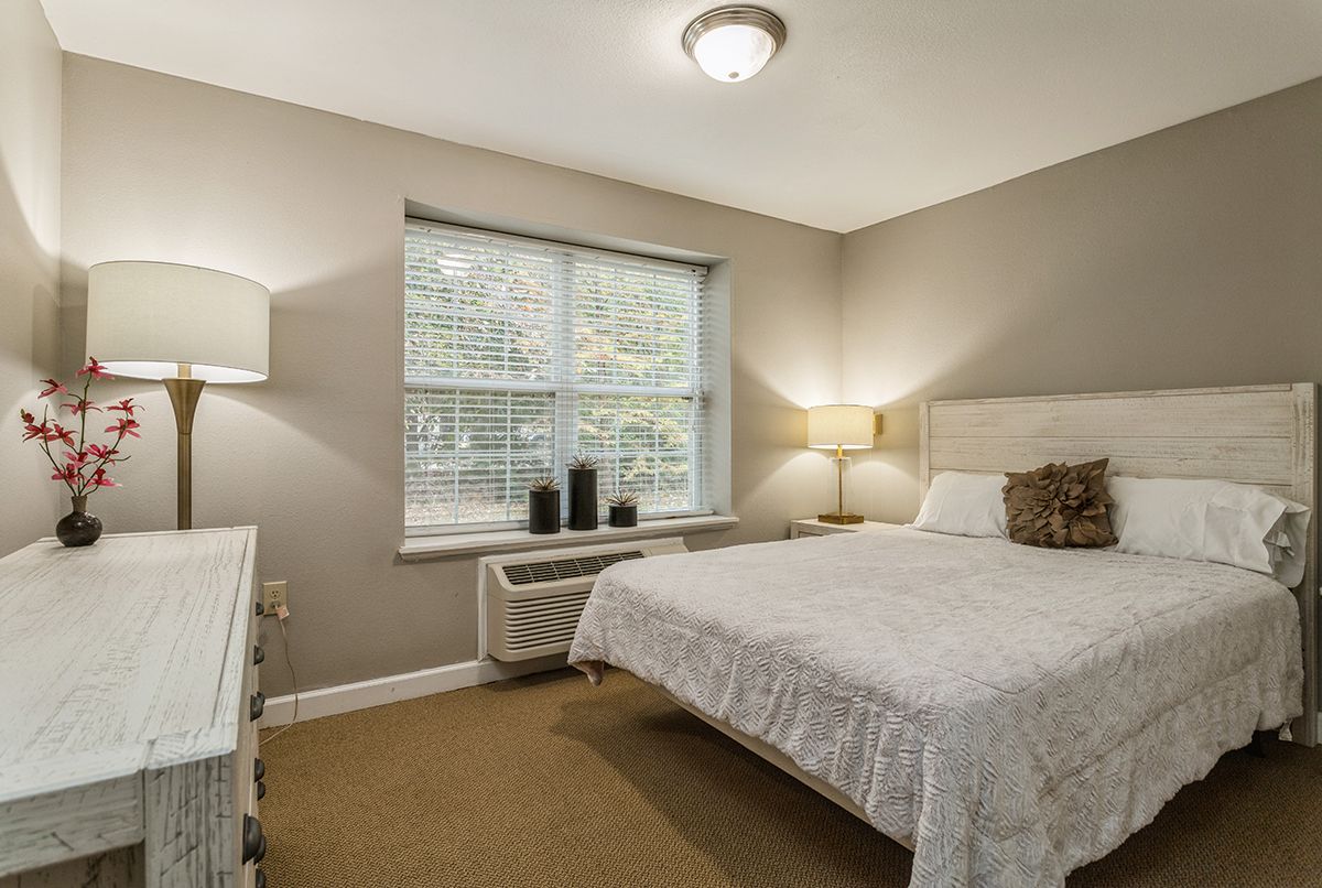 Interior of a bedroom at Cypress Place Senior Living with tasteful decor and furniture.