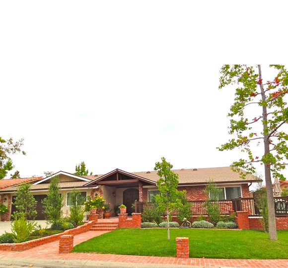 Cheerful Heart Home V, a senior living community with lush lawns, trees, and modern villas.