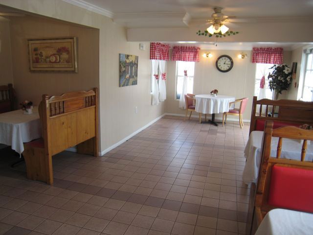 Senior living community interior at The Cottages at Artesia Gardens featuring dining room and decor.