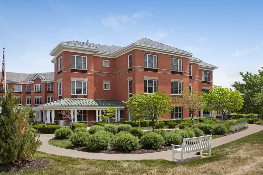 Sunrise Assisted Living of Leawood, a high-rise senior community with lush lawns and modern architecture.