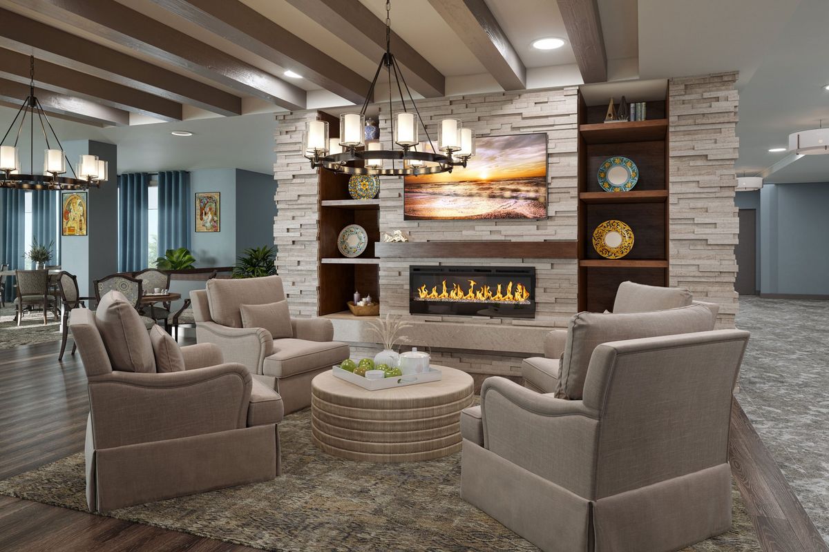 Interior view of The Gallery At North Port senior living community featuring home decor, fireplace, and dining area.