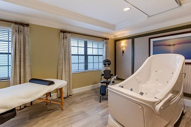 Senior enjoying a relaxing spa bath in a furnished room at Brookdale Sarasota Midtown.