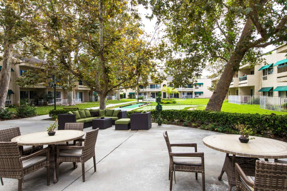 Senior living community, Citrus Place, featuring resort-style architecture, lush parks, and outdoor furniture.