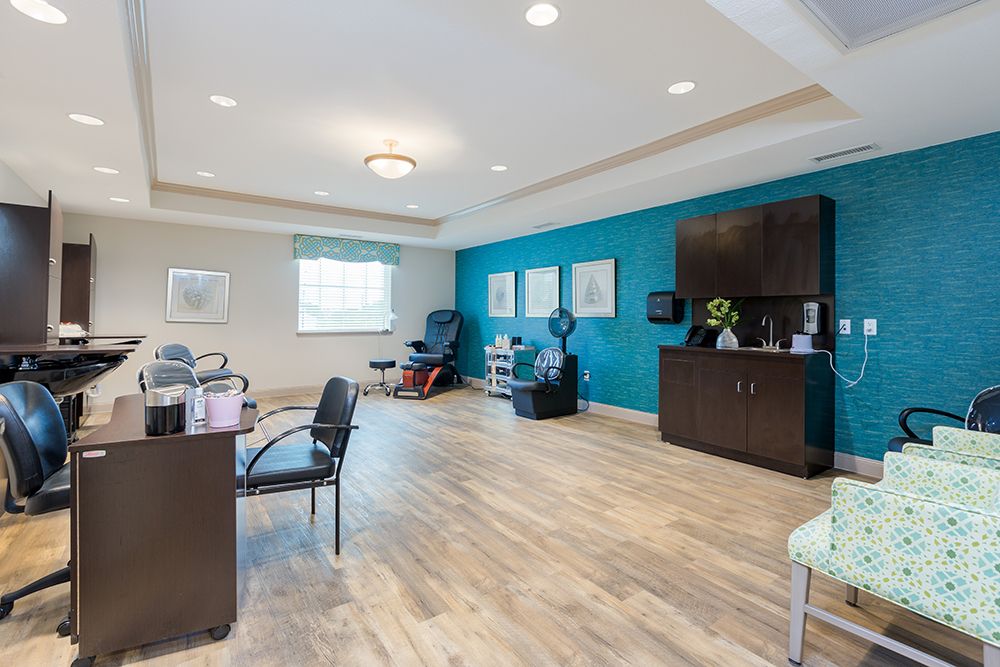 Interior view of The Enclave at Round Rock Senior Living featuring elegant furniture and beauty salon.