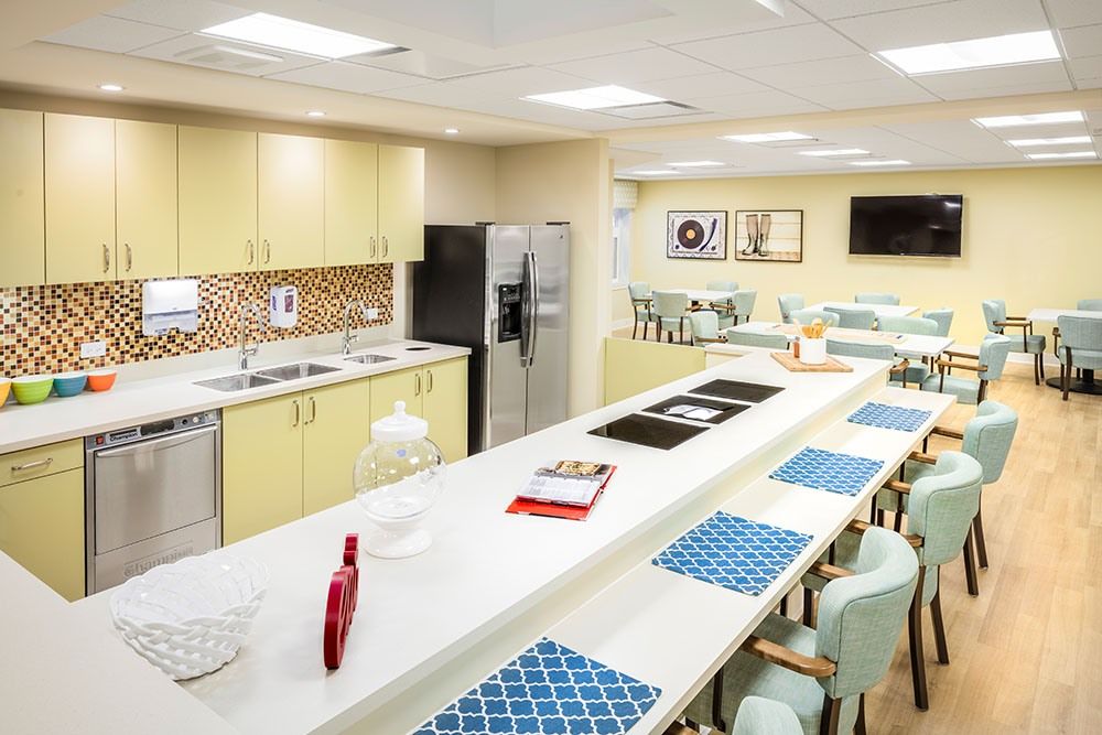 Interior view of The Sheridan At Tyler Creek senior living community featuring a modern kitchen and cafeteria.