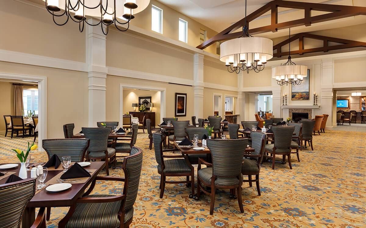 Senior living community HarborChase of Long Grove featuring elegant dining room, lounge, and foyer.
