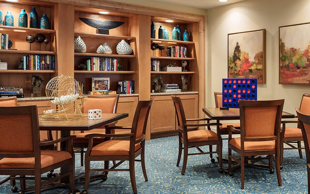 Interior view of HarborChase of Long Grove senior living community featuring dining room, furniture, and art decor.