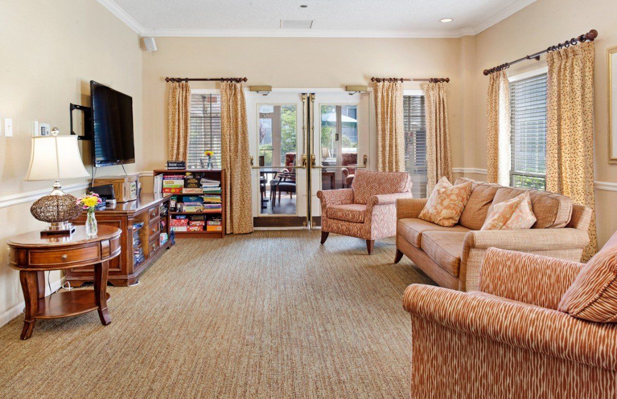 Interior view of Brighton Gardens of Edison senior living room with modern decor and electronics.