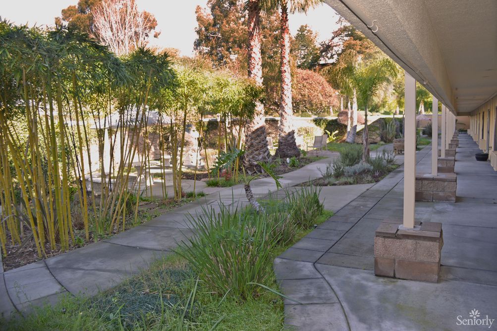 Pathway leading to St. Regis Retirement Center with flagstone architecture and garden patio.